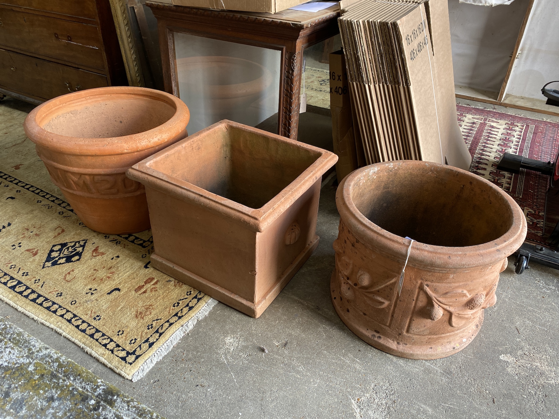 Three large square and circular terracotta garden planters, largest diameter 58cm, height 42cm